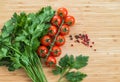 Fresh vegetables on the table, copy space. Food background. Flat lay. Cherry tomatoes, a bunch of parsley, black and red Royalty Free Stock Photo