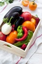 Fresh vegetables, tomatoes, peppers, aubergines, chilli pepper in a wooden box in the open air. Royalty Free Stock Photo