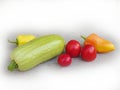 Fresh vegetables on a white background. Zucchini, peppers and tomatoes Royalty Free Stock Photo