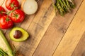 Fresh vegetables on wooden background. View from above. Vegetarian sets. Harvest. Gastronomy. Avocado. Asparagus. Tomatoes. Carrot