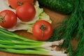 Fresh vegetables on a chopping wooden board, about to turn into a salad. Royalty Free Stock Photo