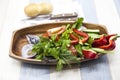 Fresh vegetables on a wooden plate with fork and knife. Red pepper, tomato, cucumber, radish, parsley, dill healthy diet. Royalty Free Stock Photo