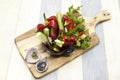 Fresh vegetables on a wooden plate. Red pepper, tomato, cucumber, radish, parsley, dill healthy diet. Royalty Free Stock Photo