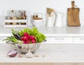 Fresh vegetables on wooden table over blurred kitchen counter interior Royalty Free Stock Photo