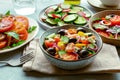 Fresh vegetarian salads, an assortment. Variety of plates and bowls