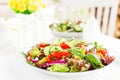 Fresh vegetarian vegetable salad with tomato, onion, cucumber, pepper, basil and lettuce. Salad on plate Royalty Free Stock Photo