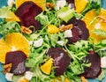 Fresh vegeterian salad with beetroot, orange and arugula background