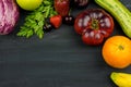 FRESH VEGTABLES AND FRUIT ON BLACK CHALK BACKGROUND