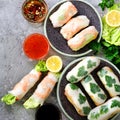 Fresh Vietnamese, Asian, Chinese food frame on grey concrete background. Spring rolls rice paper, lettuce, salad