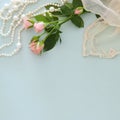 fresh vintage pearls next to aromatic flowers on wooden table.