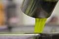 Fresh virgin olive oil pouring into tank at a cold-press factory after the olive harvesting, Crete, Greece. Royalty Free Stock Photo