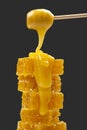 Fresh viscous flower honey falls down from a wooden spoon. vitamin organic food