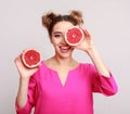 Beauty woman with citrus grapefruit halves, grey background Royalty Free Stock Photo