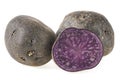 Fresh vitelotte potatoes isolated on white background. Vitolette noir or purple potato