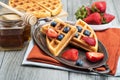 Fresh waffles with honey, strawberries and blueberries Royalty Free Stock Photo