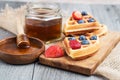 Fresh waffles with honey, strawberries and blueberries Royalty Free Stock Photo