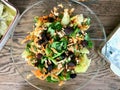 Fresh Walnut Salad with Grated Carrot Slices in Glass Bowl at Dinner Table Royalty Free Stock Photo