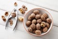 Fresh walnuts bowl on white wooden background