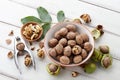 Fresh walnuts bowl on white wooden background