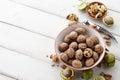 Fresh walnuts bowl on white wooden background