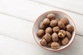 Fresh walnuts bowl on white wooden background Royalty Free Stock Photo