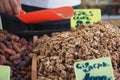 Fresh walnuts and dates at a bustling market stall Royalty Free Stock Photo
