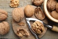 Fresh walnuts and nutcracker on wooden table, flat lay Royalty Free Stock Photo