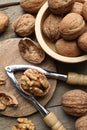 Fresh walnuts and nutcracker on wooden table, flat lay Royalty Free Stock Photo