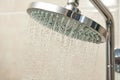 Fresh water drops pours from the shower head on the metallic stand Royalty Free Stock Photo