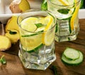 Fresh water with lemon, mint and cucumber on a wooden backgrou Royalty Free Stock Photo