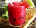 Fresh water melon smoothie on a wooden background