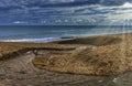 Fresh water stream going into the sea with visible sun rays - Cornwall