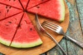 Fresh watermelon cut like pizza with forks on old shabby table Royalty Free Stock Photo