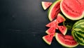 Fresh watermelon Fruits. Melon. On a black wooden background. Free space for text.