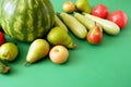 fresh watermelon, pears, apple and vegetables on green background, healthy food concept, green grocery shop Royalty Free Stock Photo