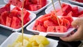 Fresh watermelon and pineapple slice in white foam plate container on black wooden table. Royalty Free Stock Photo