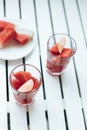 Fresh watermelon refreshing summer cocktail smoothie with lemon and ice in glass jar on white wooden board Vertical Royalty Free Stock Photo