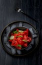 Fresh watermelon salad kept in a black bowl and plate on dark background Royalty Free Stock Photo