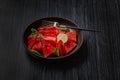 Fresh watermelon salad kept in a black plate on dark background Royalty Free Stock Photo