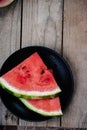 Fresh watermelon slices on a wooden background.