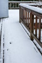 Fresh wet snow on a cedar deck, brick chimney Royalty Free Stock Photo