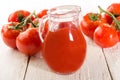 Fresh wet tomato on white wood and tomato juice Royalty Free Stock Photo