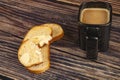 Fresh wheat toast with butter and a ceramic mug of coffee with milk on a wooden background. Close up Royalty Free Stock Photo