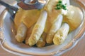 Fresh white asparagus from Beelitz on a plate with sauce hollandaise and asparagus tongs Royalty Free Stock Photo