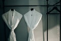 Fresh white bathrobes hanging on rack indoors Royalty Free Stock Photo