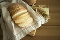 Fresh white bread on the linen textile and wooden table with milk glass and grains. Food photography -Bakery concept. slice