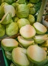 Fresh white cabbage in the market, whole and half, cut, in the shade Royalty Free Stock Photo