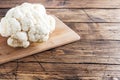 Fresh white cauliflower on a wooden background. Copy space.