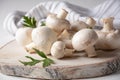 Fresh white champignon mushrooms on wooden board Royalty Free Stock Photo