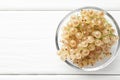 Fresh white currant berries in bowl on white wooden table, top view. Space for text Royalty Free Stock Photo